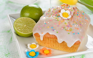 close up photo of pastry coated with glacier beside lemons on palte HD wallpaper