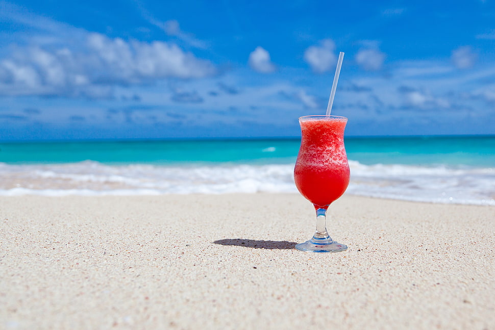 Red Slush Drink in Glass on Beach HD wallpaper