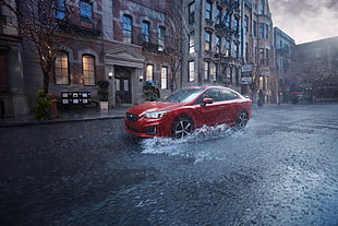 red Subaru Legacy sedan running on road during rain