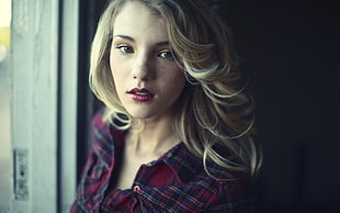 shallow focus photography of blonde haired woman in red plaid dress shirt