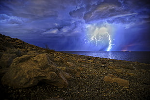 landscape photo of lightning on sea