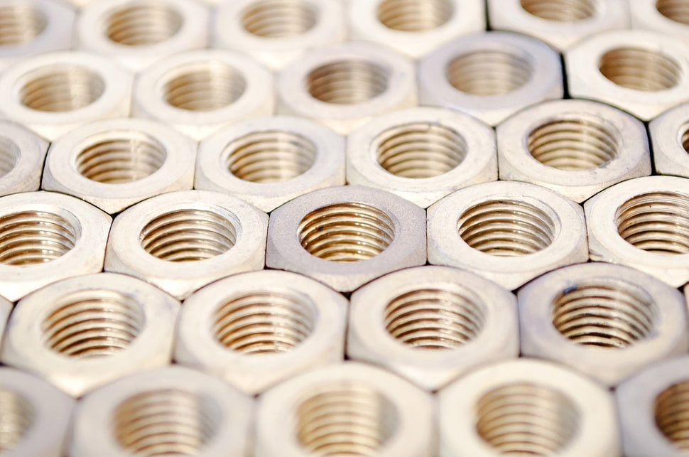 selective focus photography of piled hexagonal brass knots HD wallpaper