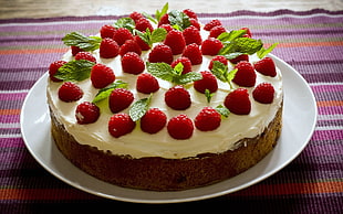 red and white strawberry cake on white ceramic plate