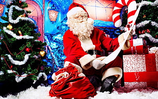Santa Claus in between christmas trees beside gift boxes