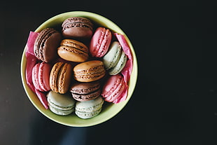 bowl of macaroons on top of black surface