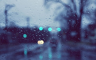 selective focus photography of rain drops outside window