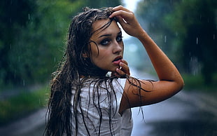 woman wearing white shirt wet under the rain