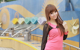 brown haired woman wearing pink and black long sleeved shirt