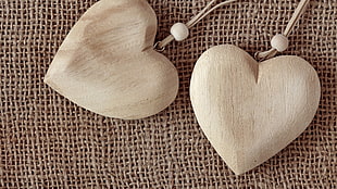 two heart-shaped brown pendants, heart