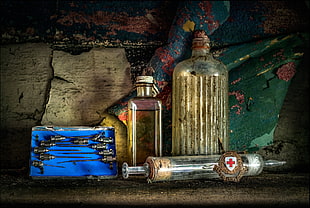 two clear glass bottles, red cross, medicine