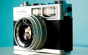 black and gray Minolta SLR camera