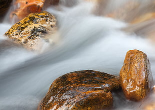 time lapse photography of waterfalls with stones