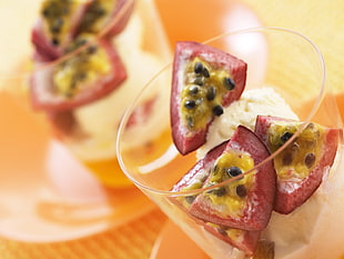 sliced red and yellow fruit in clear cocktail glass