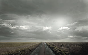 photograph of gray sky and road
