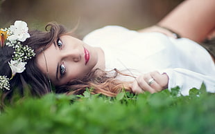 woman lying on grass with white flowers headdress HD wallpaper
