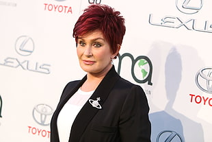woman with red hair wearing black shawl-lapel blazer