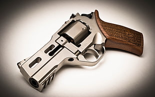 macro photography of chrome and brown revolver HD wallpaper