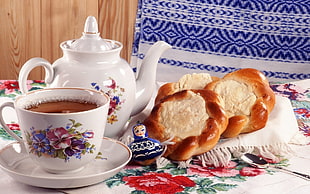 kettle beside teapot with saucer and baked bread on table HD wallpaper