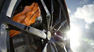 gray Lamborghini multi-spoke vehicle wheel and tire and orange Lamborghini brake caliper, sunlight, sky, car, wheels
