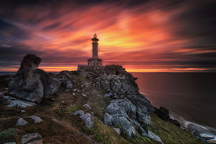 photo of lighthouse near sea HD wallpaper