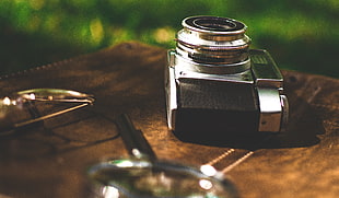tilt shift lens photography of camera on top of brown wooden table