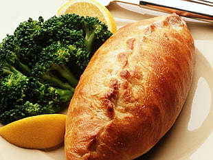 baked bread with broccoli on white surface