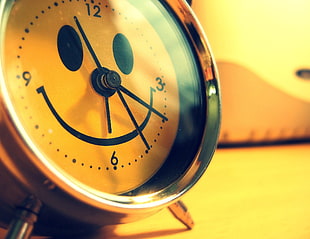 close up photography of smiling analog alarm clock