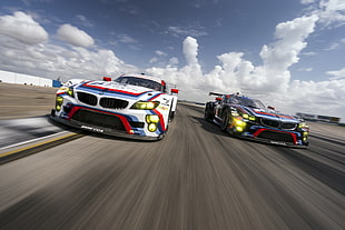 photograph of white and blue BMW cars