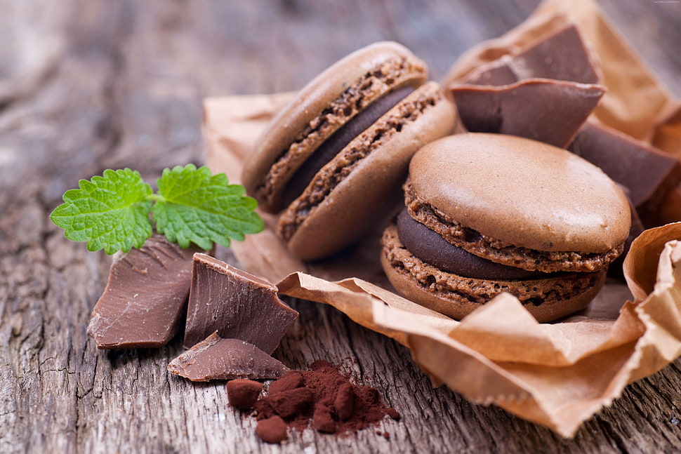 two chocolate macaroons near chocolate bits HD wallpaper