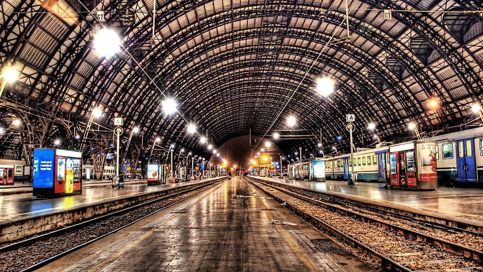 gray steel railway inside train station surrounded by assorted lights HD wallpaper