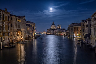 river surrounded by buildings during nighttime, santa maria della salute, venice, italy