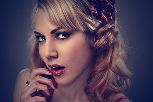 woman with red lipstick and nasal piercing