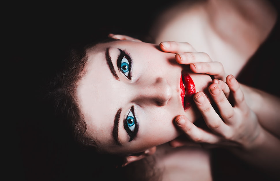 woman with red lips holding face HD wallpaper