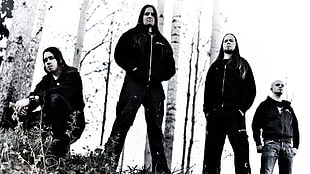 four men wearing black jackets
