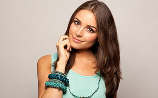 woman wearing teal tank top with bangles