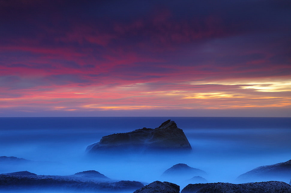 mountain range under red and yellow sky HD wallpaper