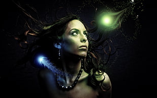 brunette haired female with blue and green orb