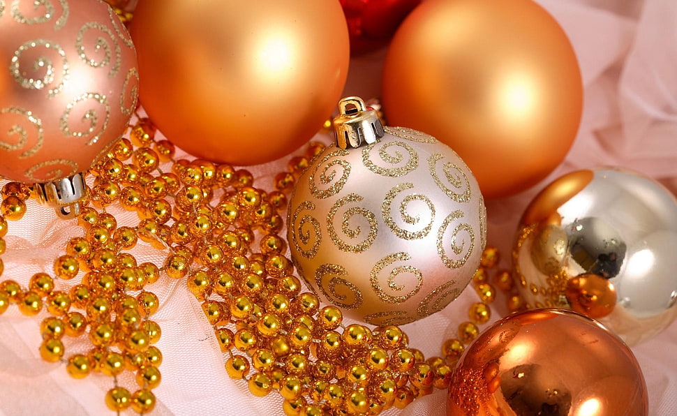 closeup photography of orange Christmas baubles on top of pink textile HD wallpaper