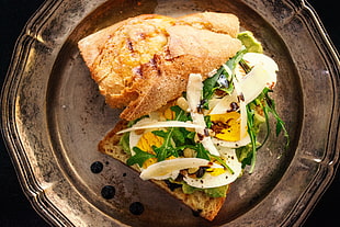 plate of sandwich with egg and herb
