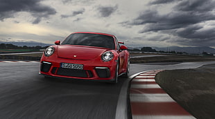 red Porsche 911 on race track during daytime HD wallpaper