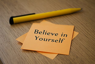 orange sticky note with Believe in Yourself text