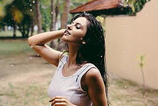 woman wearing white tank top with wet hair at daytime