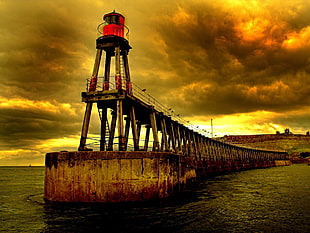 brown bridge on seaside during sunset