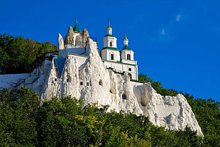white and green concrete church on mountain photo