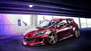 red 3-door hatchback in front gray building