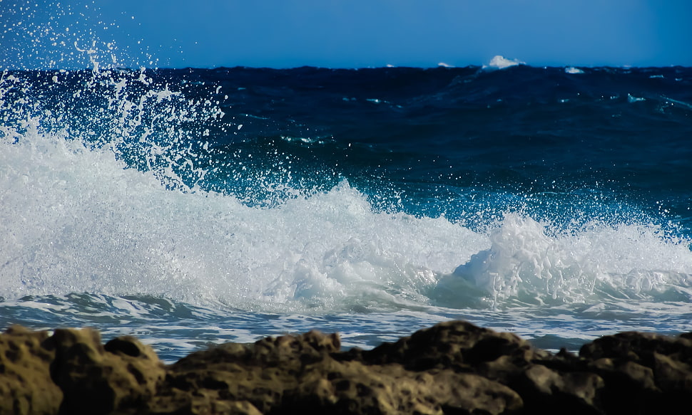 wave crashing through rock HD wallpaper