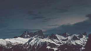 black and white snow mountain under dark sky