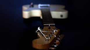 selective focus photography of brown guitar headstock