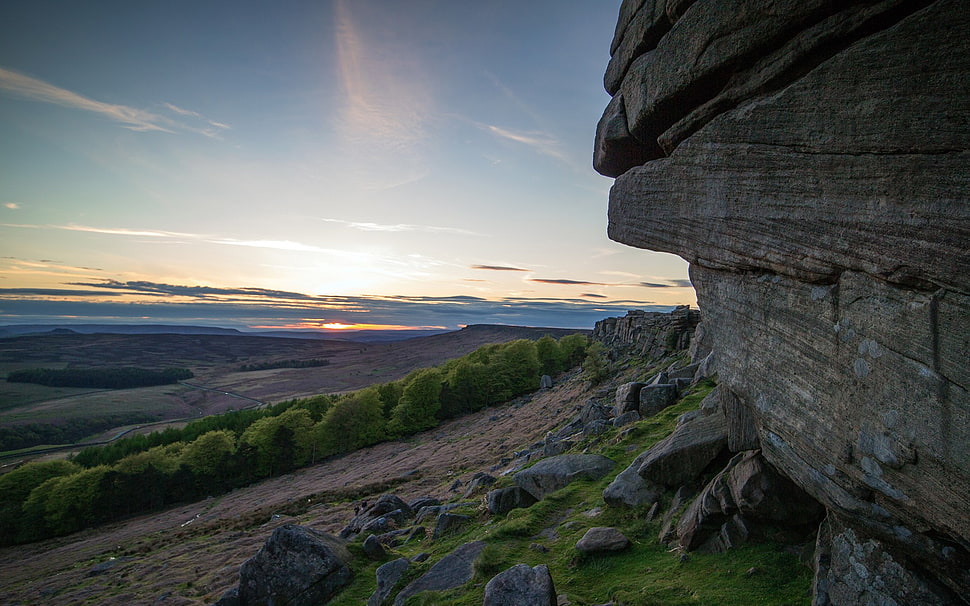 rock formation and green leaf shrub at daytime HD wallpaper