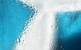 macro photography of water droplets on clear glass